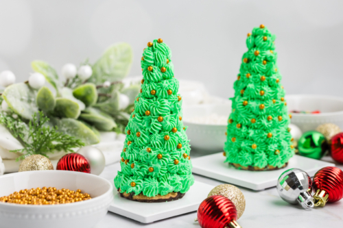 straight on shot of two christmas tree cake cones with gold decorations