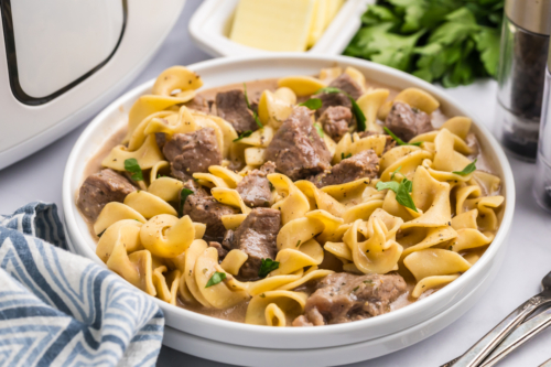 angled shot of plate of crock pot beef and noodles