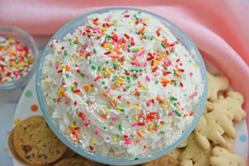 close up angled shot of bowl of funfetti cake batter dip
