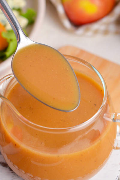 angled shot of spoon in maple dijon dressing