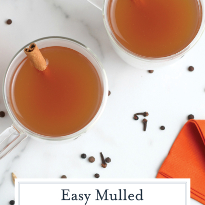 overhead shot of two mugs of mulled cider with text overlay