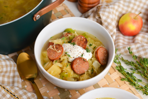 angled shot of bowl of sausage and sauerkraut soup