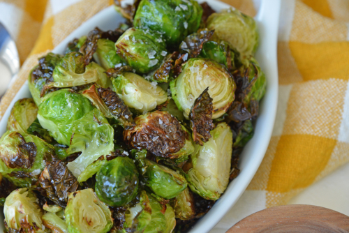 close up shot of air fryer brussels sprouts in serving dish