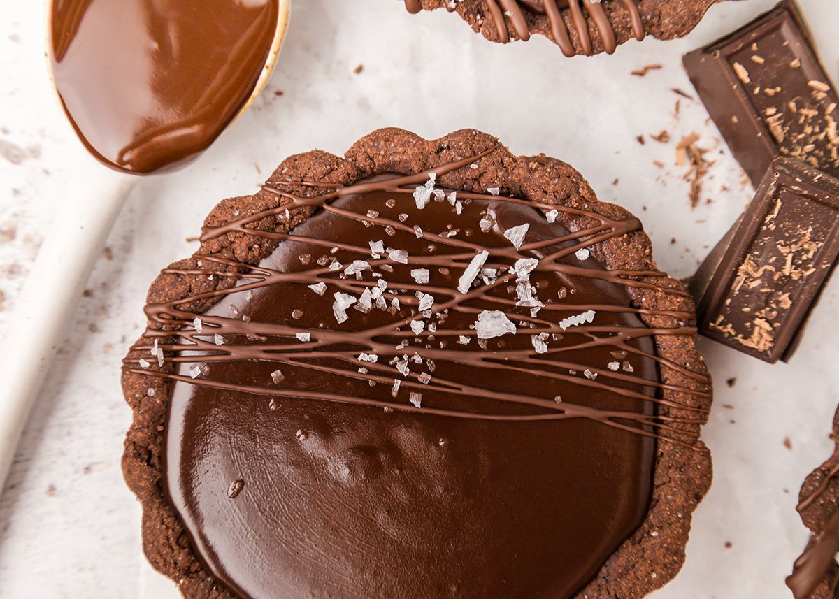 close up of sea salt sprinkled onto chocolate tart