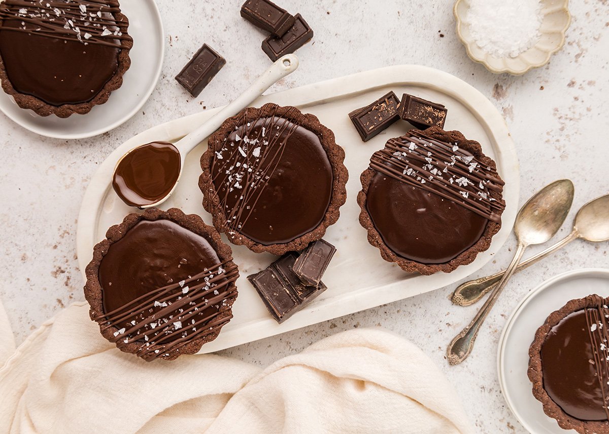 overhead shot of three mini chocolate tarts on tray