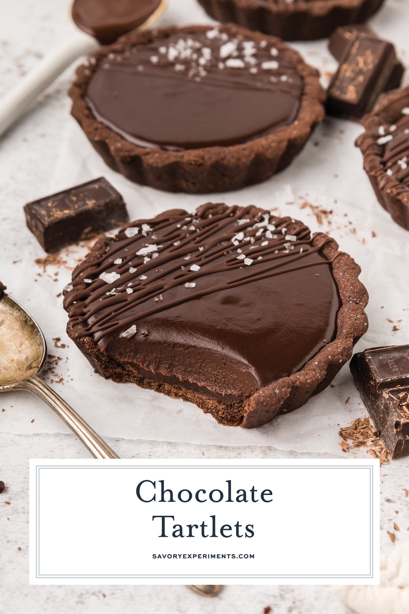 angled shot of bite taken out of chocolate tartlets with text overlay