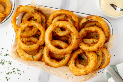 overhead shot of platter of beer battered onions rings