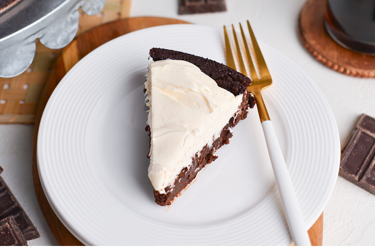 slice of flourless guinness cake on plate with fork