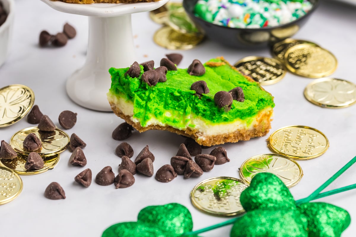 angled shot of bite taken out of grasshopper cheesecake bar