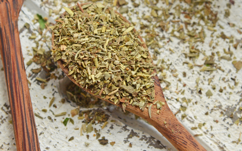 close up of italian spices in a wooden spoon