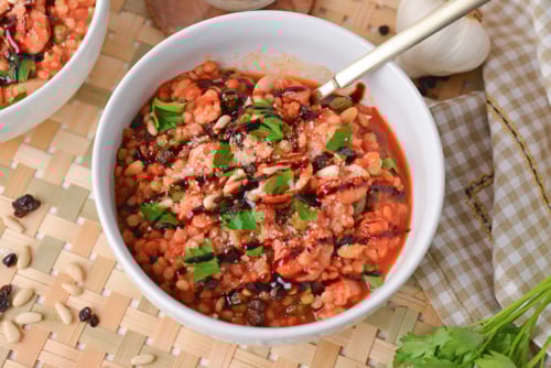 angled shot of spoon in bowl of cioppino