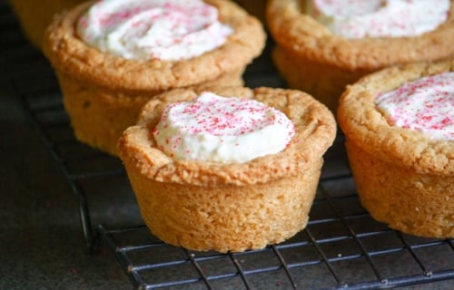 angled shot of raspberry cheesecake cookie cups on cooling rack