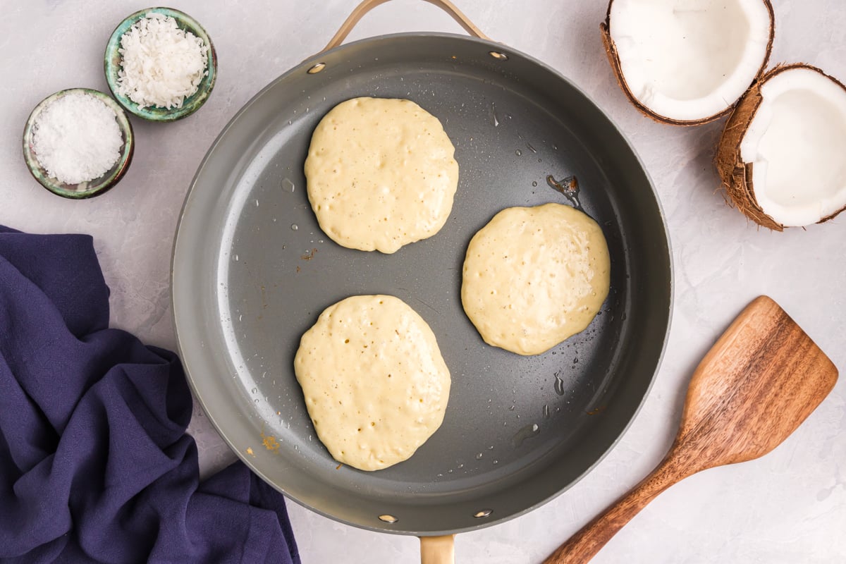 overhead shot of three pancakes in skillet