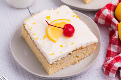 angled shot of slice of lemon sheet cake on plate