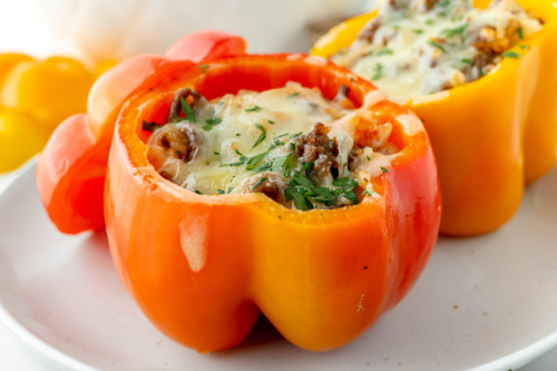 angled shot of red stuffed pepper on plate