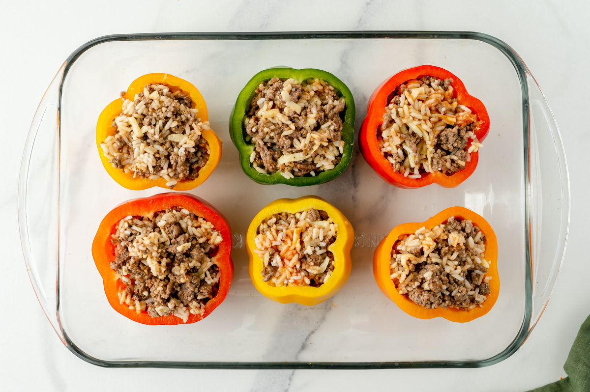 overhead shot of peppers with filling in baking dish