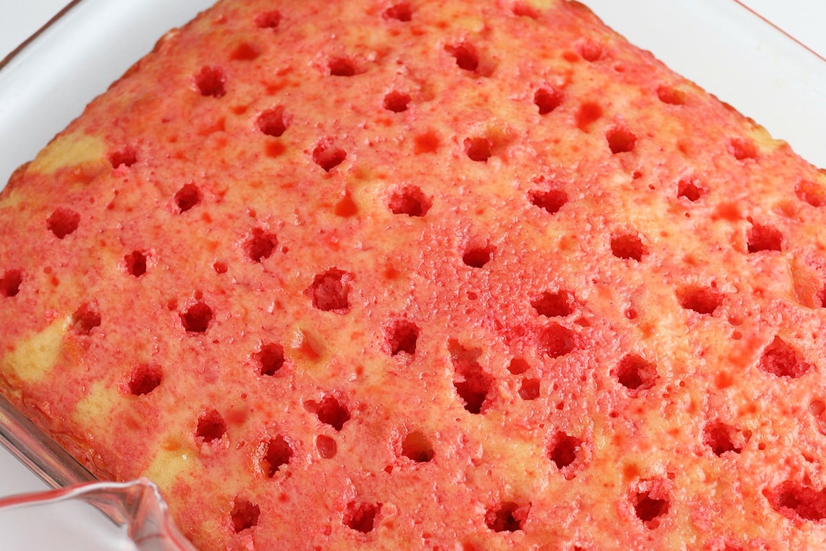 holes poked in cherry cake