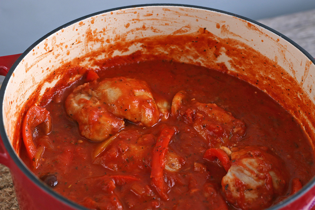 angled shot of chicken cacciatore in dutch oven