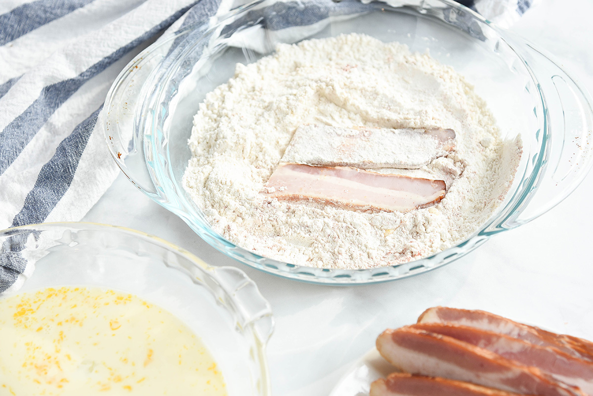 bacon slice in bowl of flour