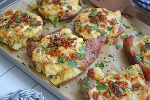 angled shot of crab smashed potatoes on baking sheet