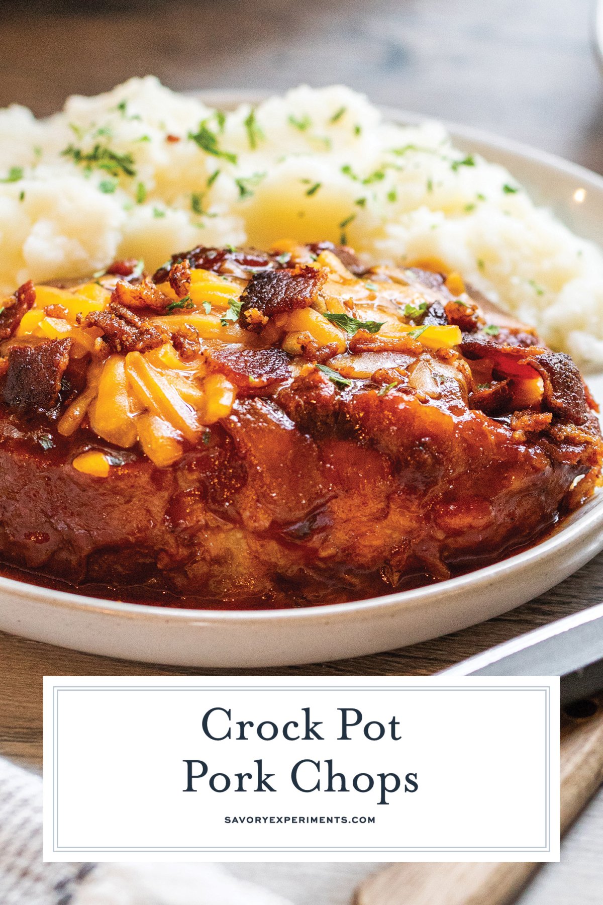 angled shot of crock pot pork chops on plate with text overlay