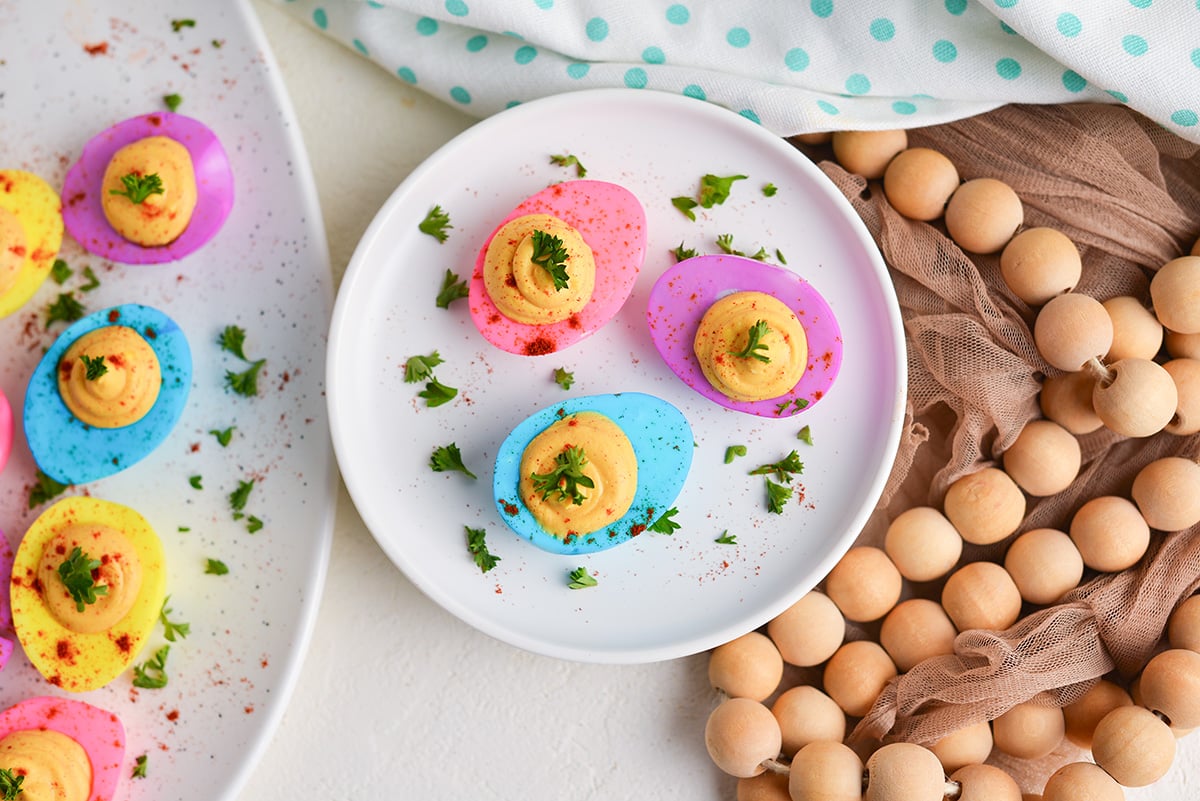 overhead shot of plate of three dyed deviled eggs