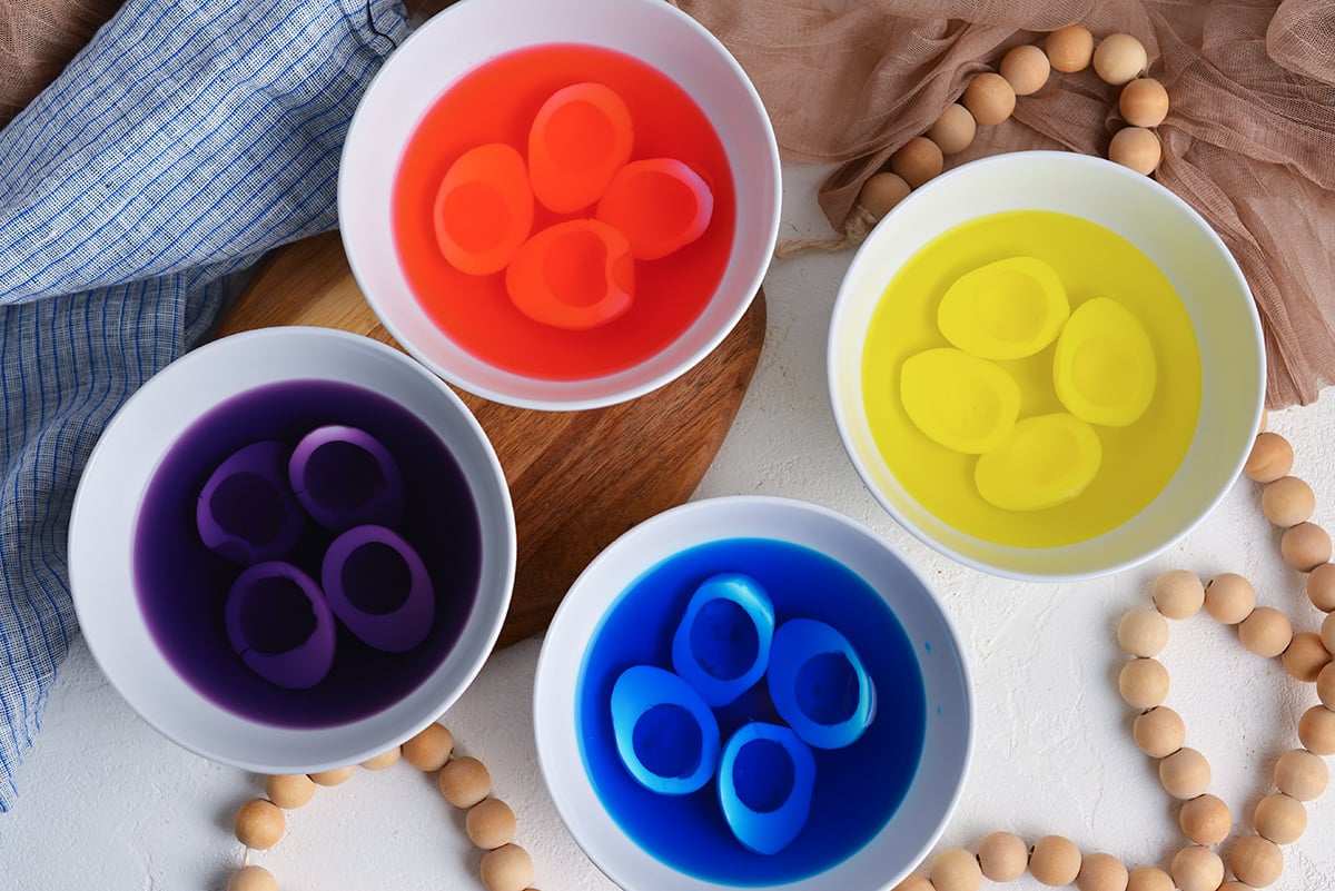 boiled egg whites in bowls of food dye