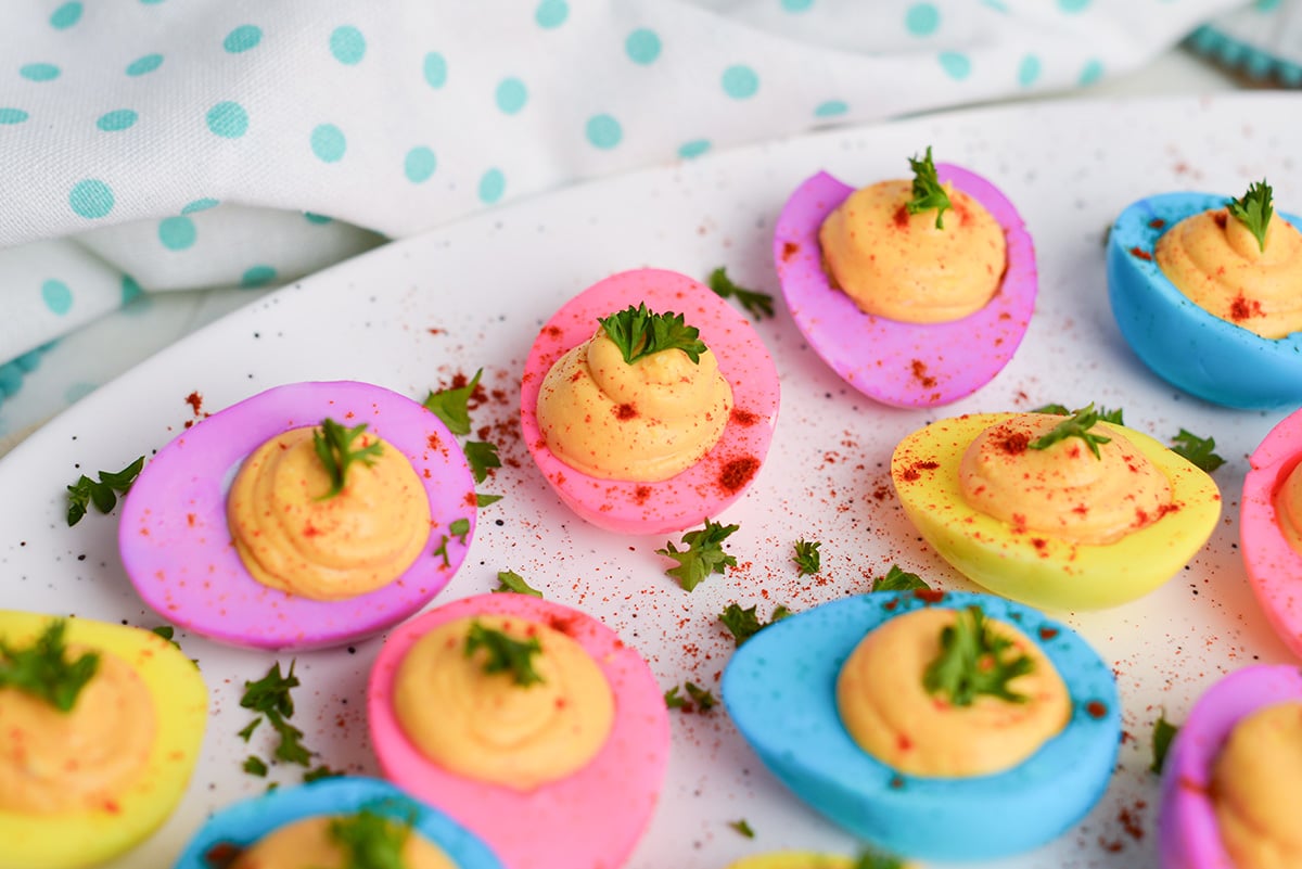 angled shot of platter of dyed deviled eggs