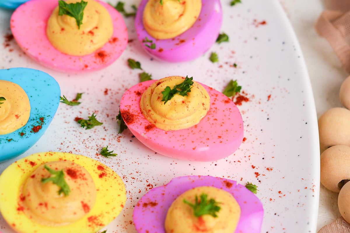 close up angled shot of dyed deviled eggs on platter