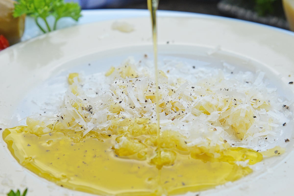 close up of plate of garlic parmesan olive oil bread dip