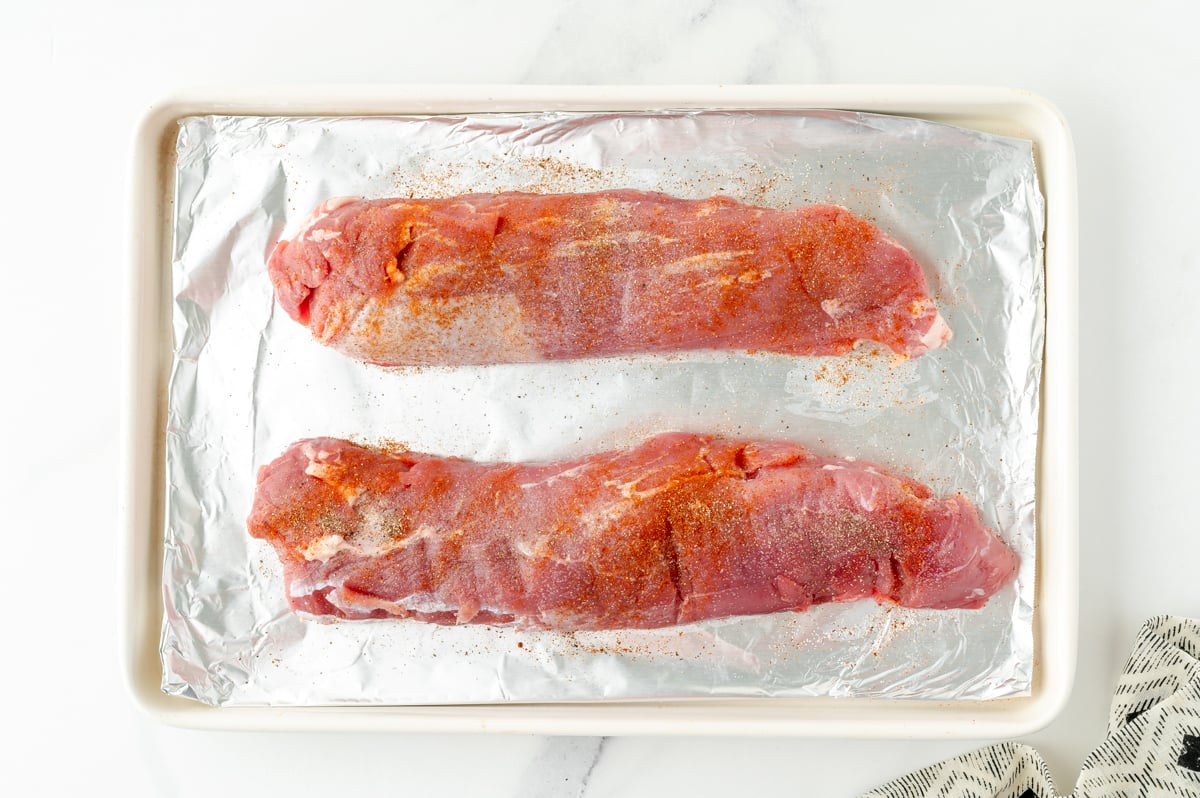 overhead shot of raw pork tenderloins on sheet pan