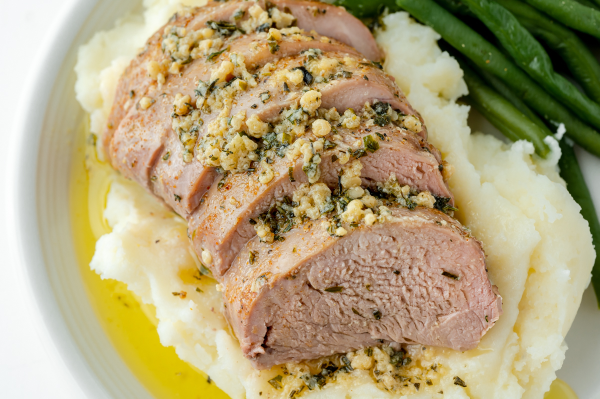 sliced pork tenderloin medallions over mashed potatoes