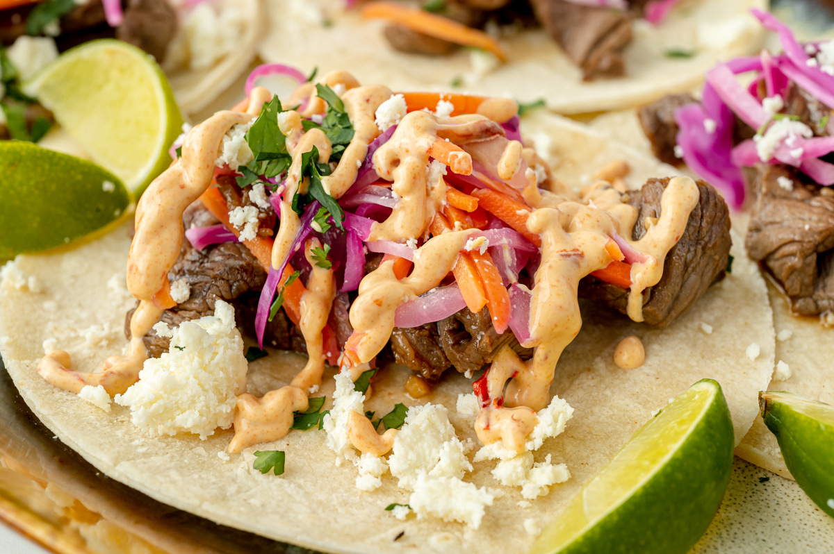 angled shot of chipotle aioli drizzled onto korean taco