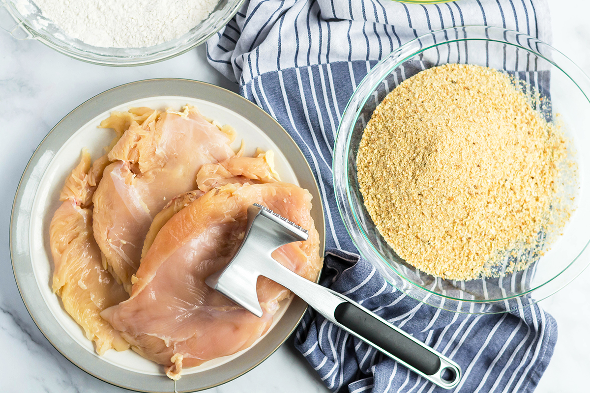 Raw chicken breasts with bread crumbs