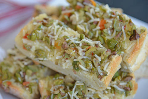 angled shot of slices of olive cheese bread