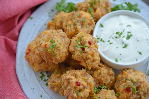 close up angled shot of plate of pimento cheese sausage balls