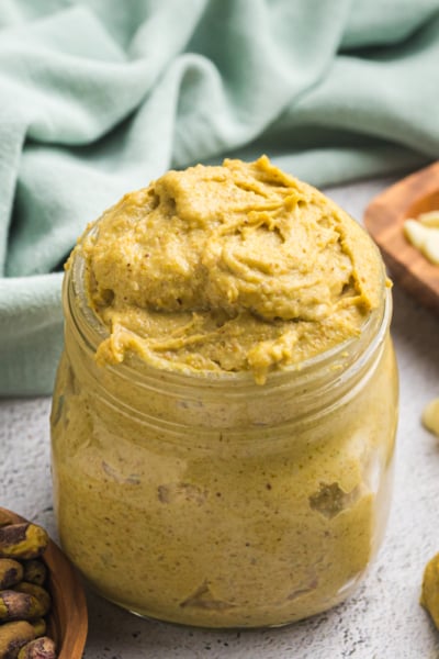 angled shot of jar of pistachio cream