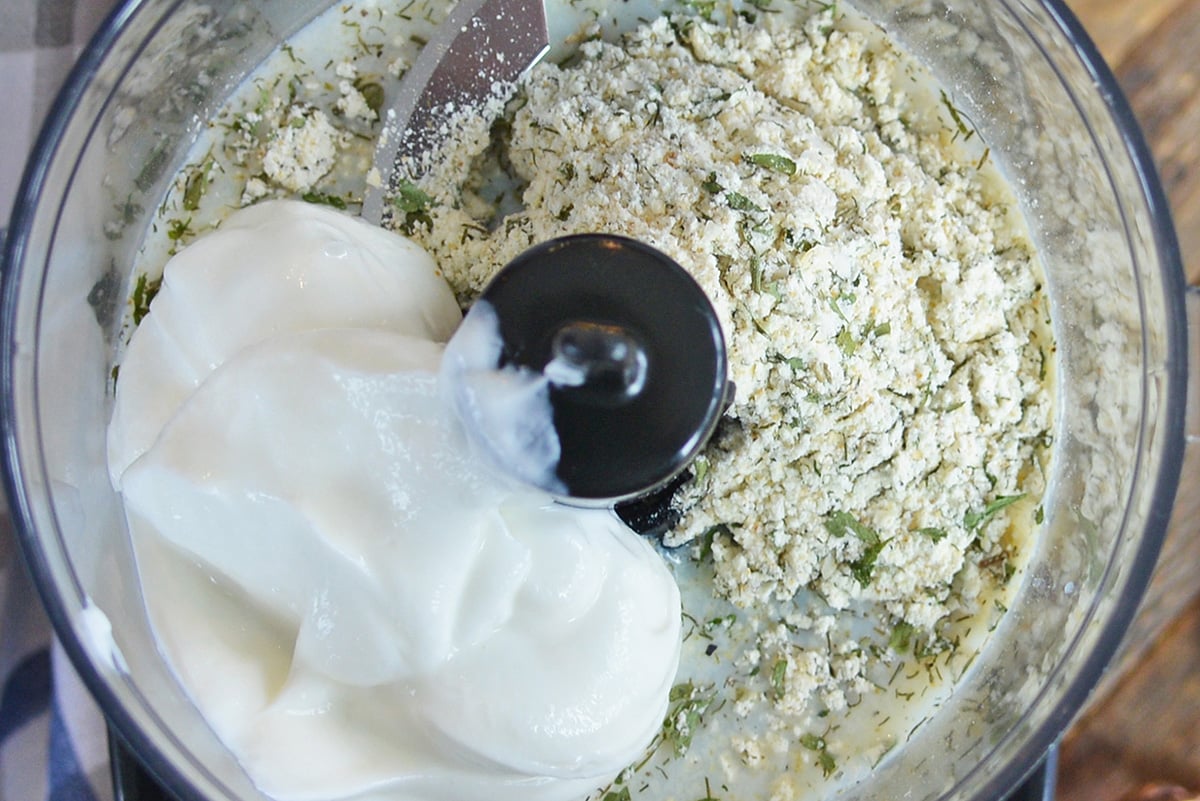 close up overhead shot of homemade ranch dressing ingredients in food processor