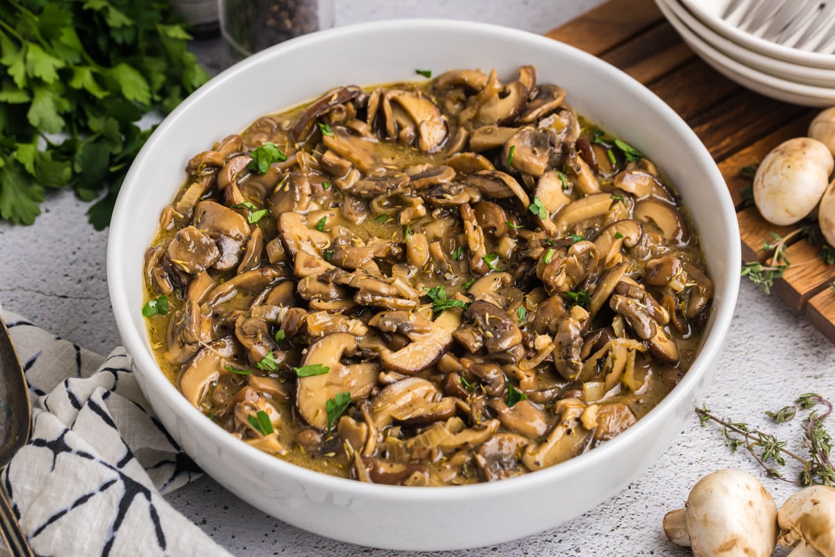 close up angled shot of bowl of sauteed mushrooms