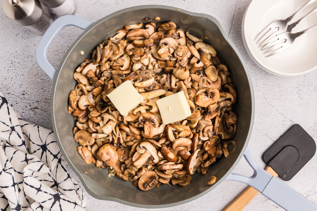 butter and mushrooms in pan