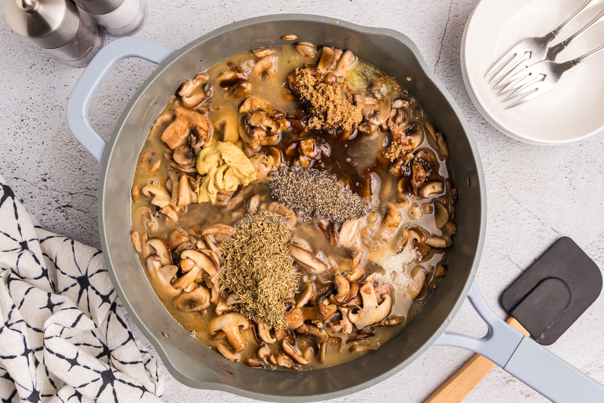 seasonings added to pan of cooking mushrooms