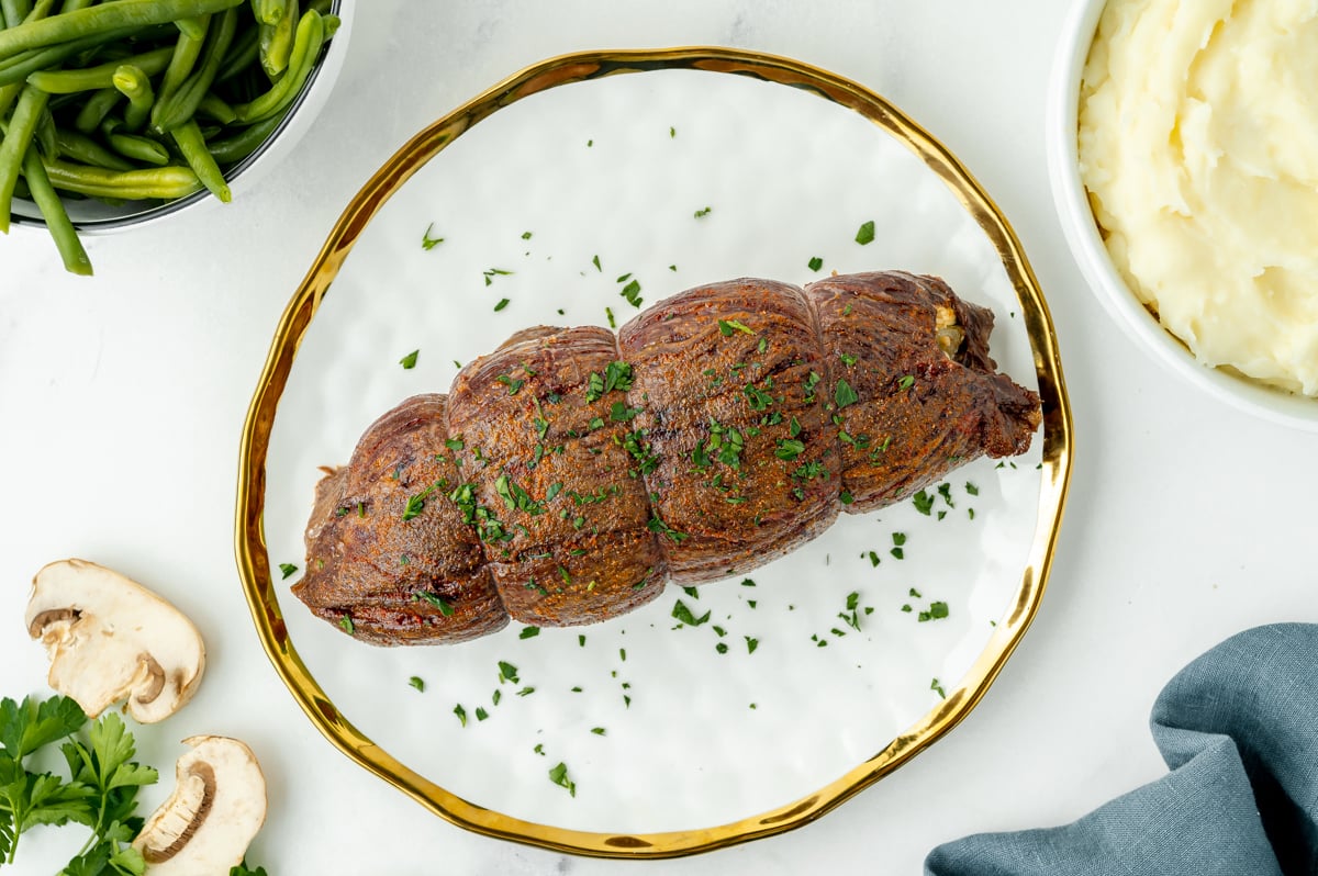 overhead shot of cooked flank steak on plate