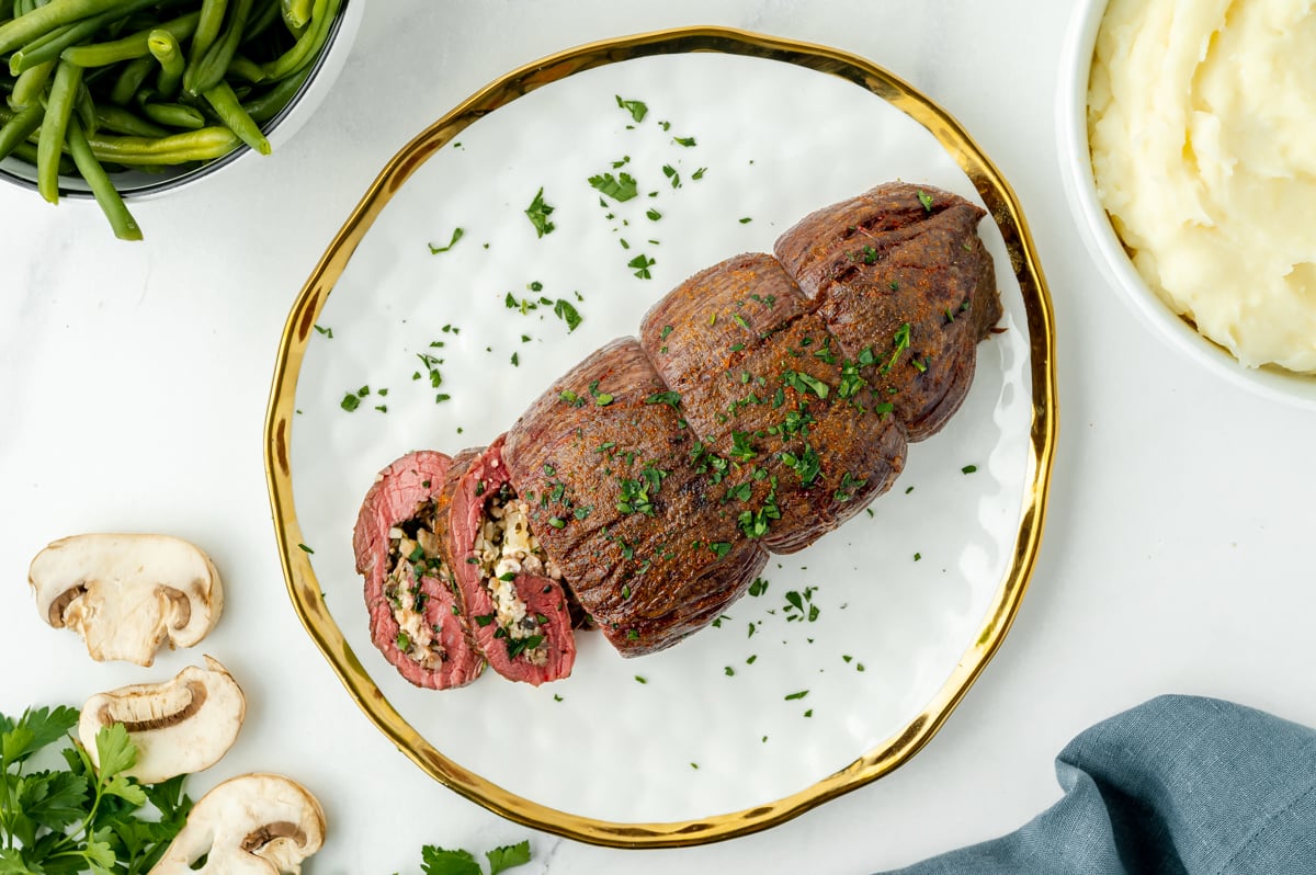 overhead shot of sliced stuffed flank steak on plate