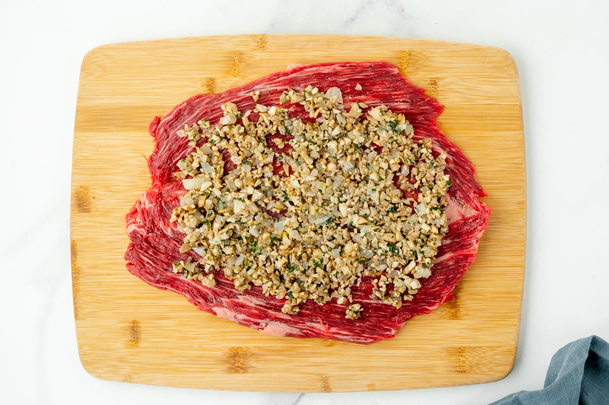 overhead shot of filling o top of flank steak on cutting board