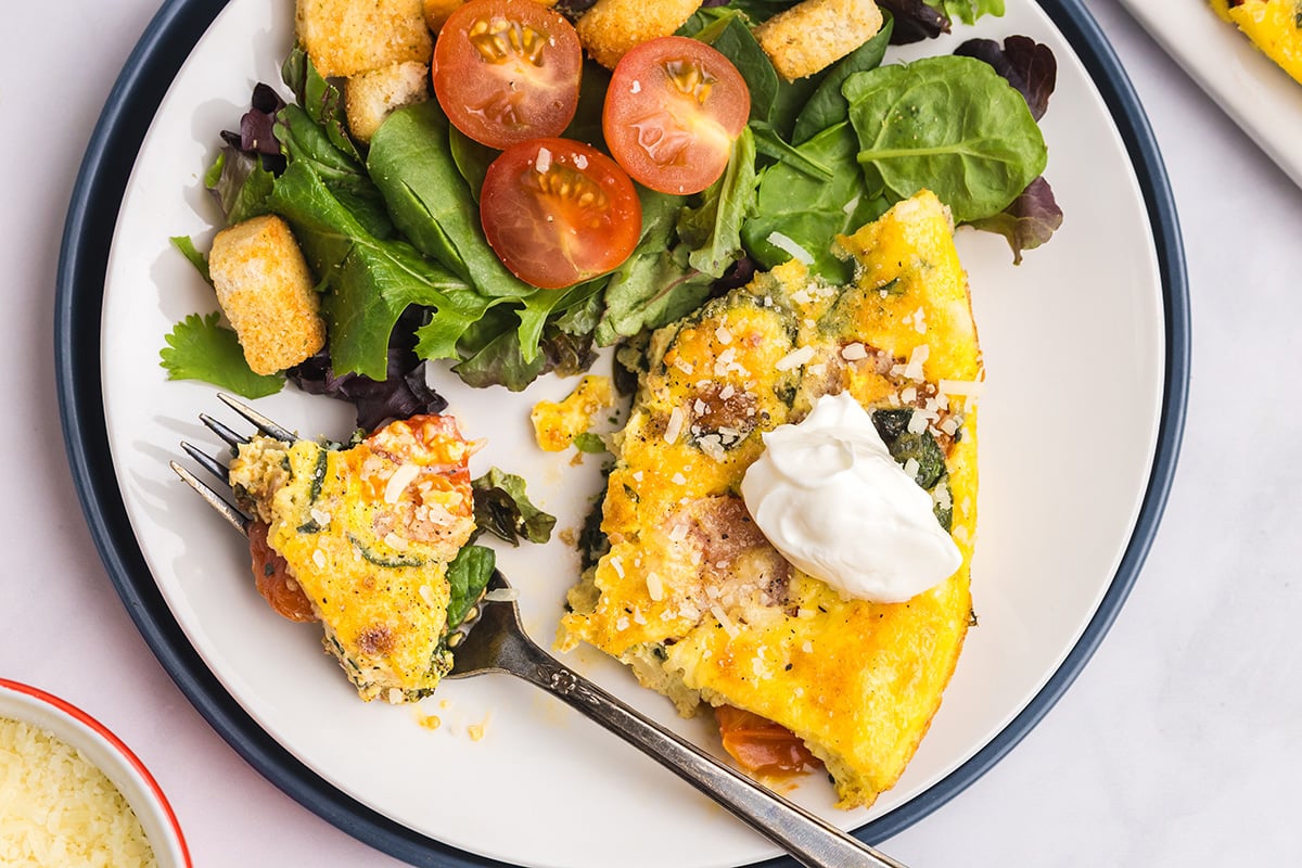 overhead shot of bite of frittata on fork