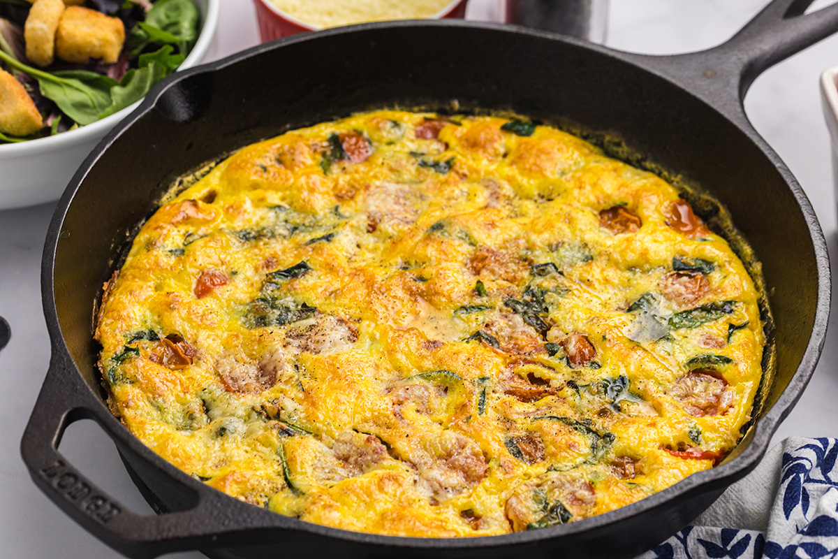 close up angled shot of tomato spinach frittata