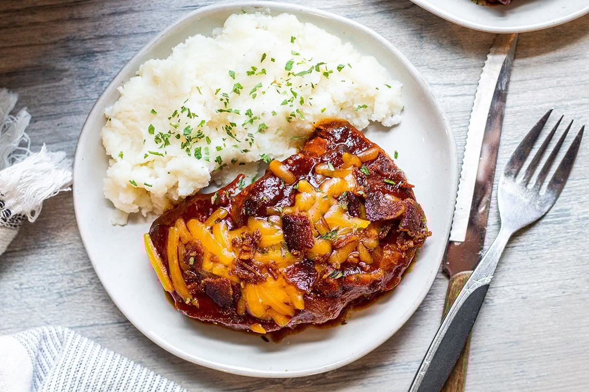 overhead shot of crock pot pork chop on plate with potatoes