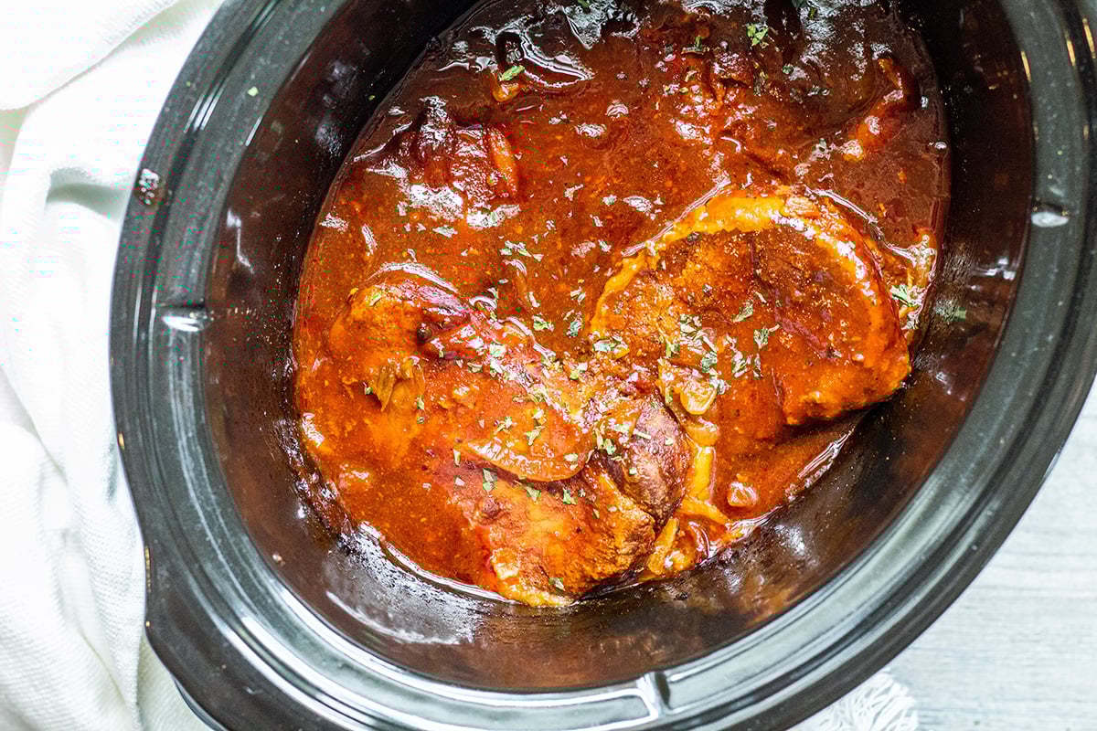 overhead shot of pork chops in crock pot