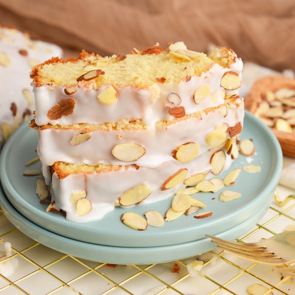 angled shot of three slices of almond pound cake on plate