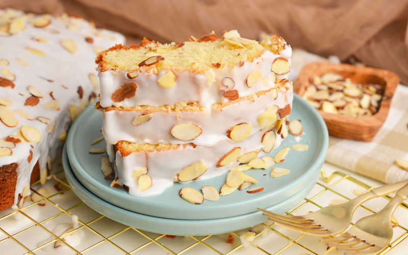 angled shot of three slices of almond pound cake on plate